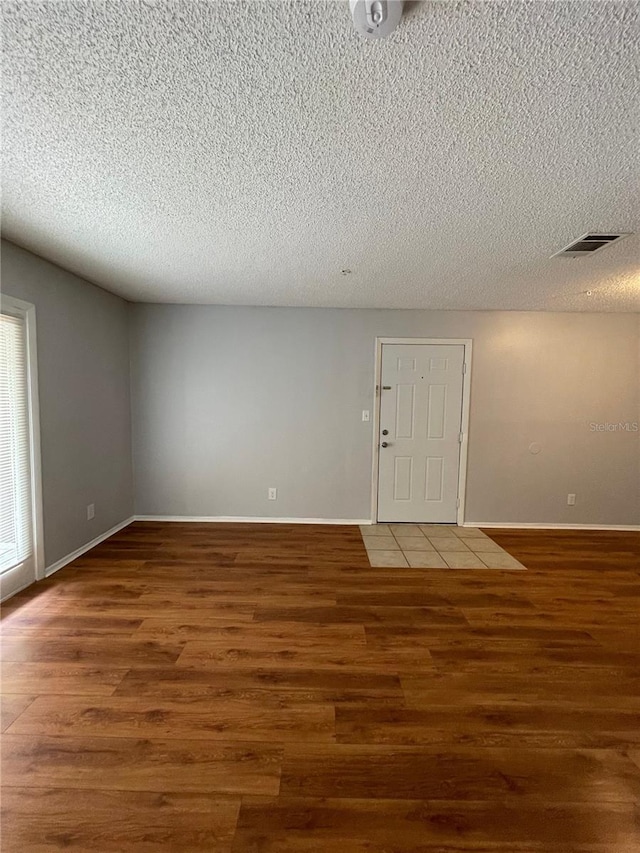238 Afton Sq Unit 204, Altamonte Springs, FL 32714 - spare room featuring wood finished floors, a textured ceiling, and baseboards