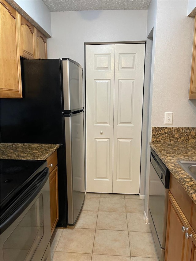 238 Afton Sq Unit 204, Altamonte Springs, FL 32714 - kitchen with dishwasher, electric range oven, a textured ceiling, light tile patterned floors, and dark stone counters