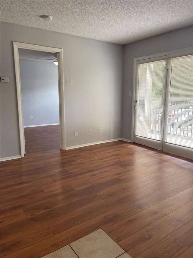 238 Afton Sq Unit 204, Altamonte Springs, FL 32714 - unfurnished room with wood-type flooring, a textured ceiling, baseboards, and a smoke detector