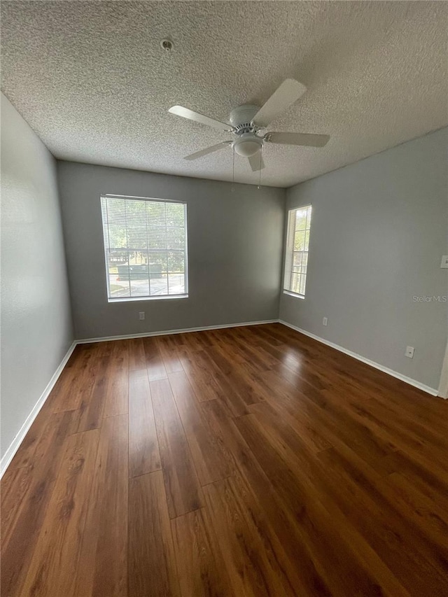 238 Afton Sq Unit 204, Altamonte Springs, FL 32714 - unfurnished room featuring dark wood-style floors, a textured ceiling, ceiling fan, and baseboards