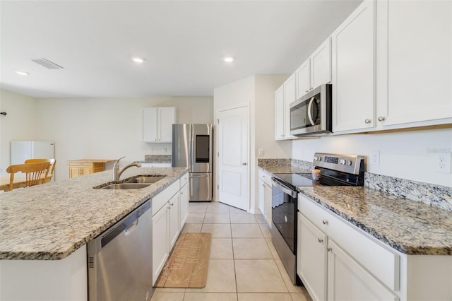 2135 E Old Mill Dr, Deltona, FL 32725 - kitchen with appliances with stainless steel finishes, a sink, white cabinetry, and recessed lighting