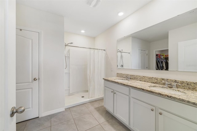 2135 E Old Mill Dr, Deltona, FL 32725 - full bathroom featuring a stall shower, tile patterned flooring, double vanity, and a walk in closet