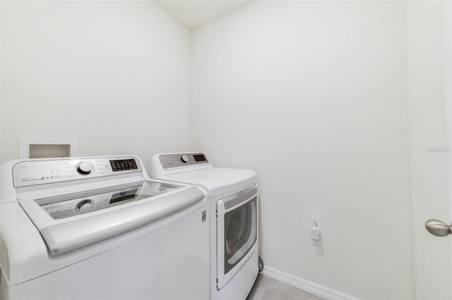 2135 E Old Mill Dr, Deltona, FL 32725 - washroom with washer and clothes dryer, baseboards, and light tile patterned floors