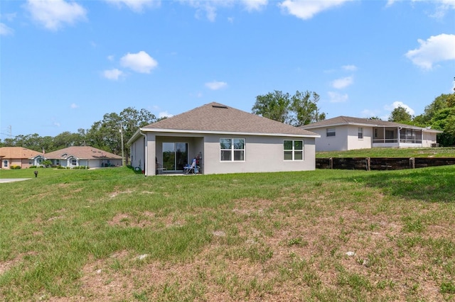 2135 E Old Mill Dr, Deltona, FL 32725 - back of property featuring a lawn and stucco siding