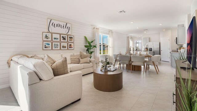 1325 June Lake Loop, Haines City, FL 33844 - living room with recessed lighting, light tile patterned floors, and wood walls