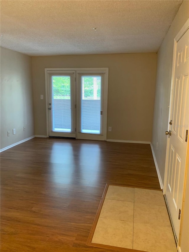 238 Afton Sq Unit 106, Altamonte Springs, FL 32714 - unfurnished room featuring a textured ceiling, wood finished floors, and baseboards