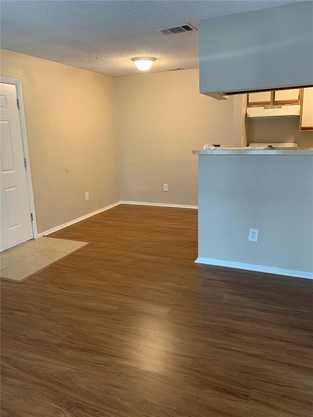 238 Afton Sq Unit 106, Altamonte Springs, FL 32714 - spare room with dark wood-style floors, a textured ceiling, and baseboards