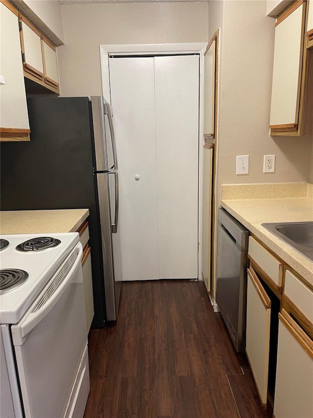 238 Afton Sq Unit 106, Altamonte Springs, FL 32714 - kitchen with appliances with stainless steel finishes, dark wood finished floors, light countertops, and a sink