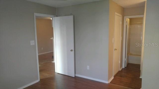 238 Afton Sq Unit 106, Altamonte Springs, FL 32714 - unfurnished bedroom featuring wood finished floors and baseboards