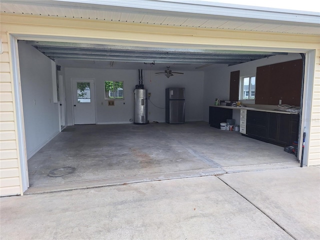 11282 SW 62nd Avenue Rd, Ocala, FL 34476 - garage with water heater, freestanding refrigerator, concrete driveway, and a ceiling fan
