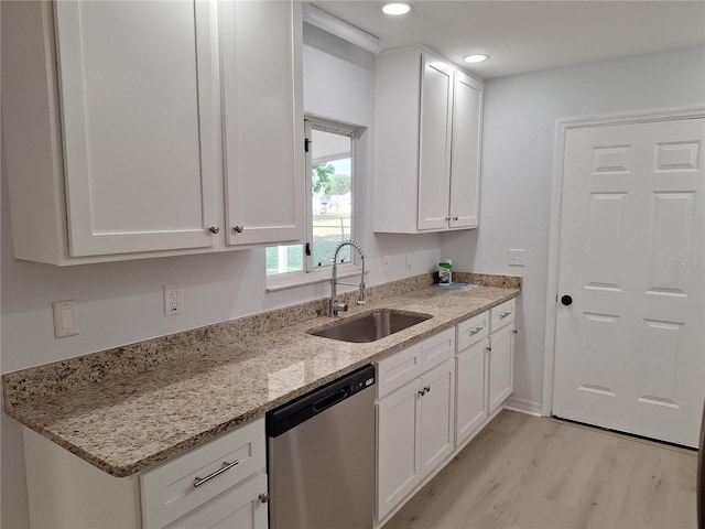 11282 SW 62nd Avenue Rd, Ocala, FL 34476 - kitchen featuring stainless steel dishwasher, a sink, white cabinets, light wood-type flooring, and light stone counters