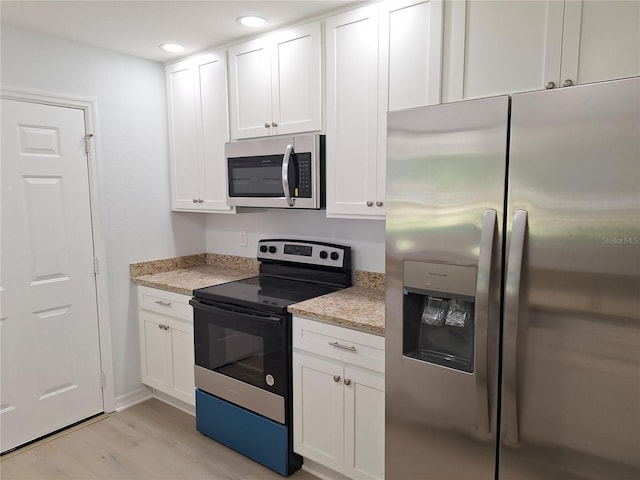 11282 SW 62nd Avenue Rd, Ocala, FL 34476 - kitchen featuring appliances with stainless steel finishes, white cabinets, light wood-type flooring, light stone counters, and recessed lighting