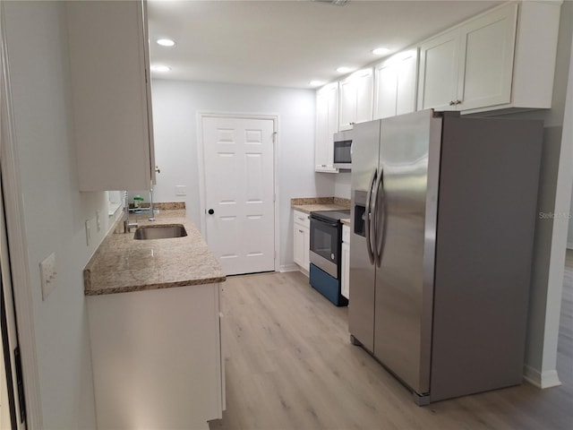 11282 SW 62nd Avenue Rd, Ocala, FL 34476 - kitchen featuring stainless steel appliances, a sink, light wood-type flooring, white cabinets, and recessed lighting