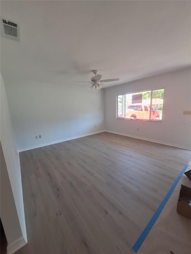 11282 SW 62nd Avenue Rd, Ocala, FL 34476 - spare room with wood finished floors, a ceiling fan, and baseboards