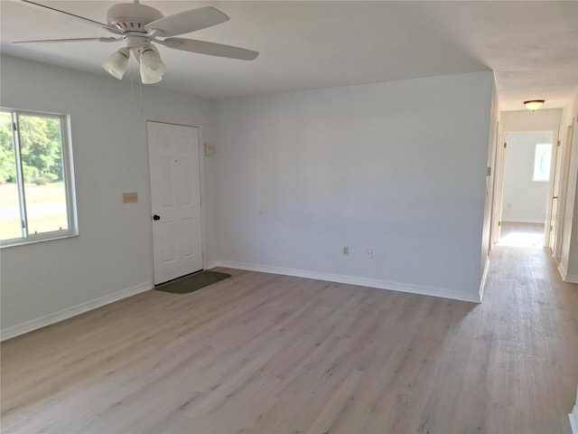 11282 SW 62nd Avenue Rd, Ocala, FL 34476 - spare room with healthy amount of natural light, light wood-type flooring, a ceiling fan, and baseboards