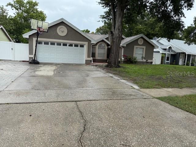 2514 Dovetail Dr, Ocoee, FL 34761 - single story home featuring concrete driveway, a garage, stucco siding, and a gate