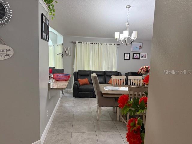 2514 Dovetail Dr, Ocoee, FL 34761 - dining space with a chandelier and tile patterned flooring