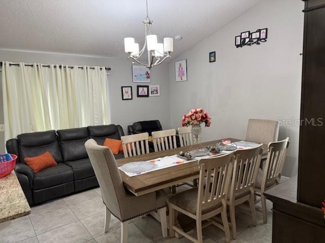 2514 Dovetail Dr, Ocoee, FL 34761 - dining area featuring a chandelier, light tile patterned flooring, and vaulted ceiling