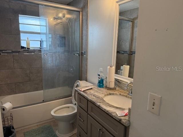 2514 Dovetail Dr, Ocoee, FL 34761 - full bathroom with vanity, toilet, and combined bath / shower with glass door