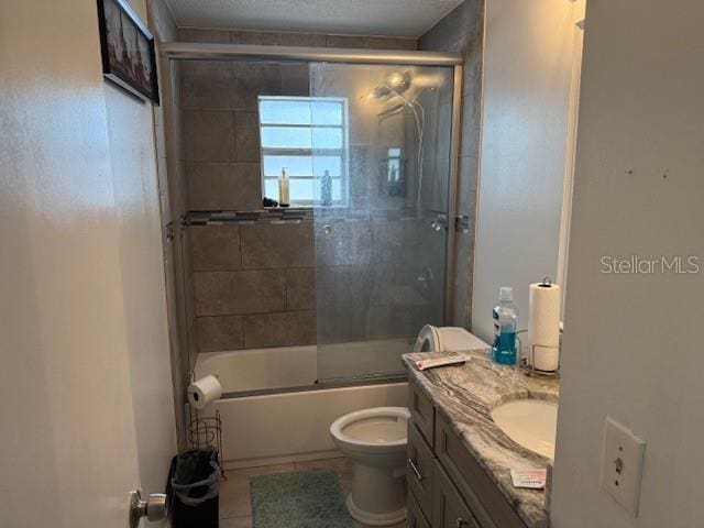 2514 Dovetail Dr, Ocoee, FL 34761 - full bathroom featuring toilet, vanity, shower / bath combination with glass door, and tile patterned flooring