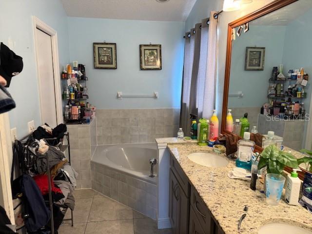2514 Dovetail Dr, Ocoee, FL 34761 - full bath featuring tile patterned flooring, double vanity, and a bath