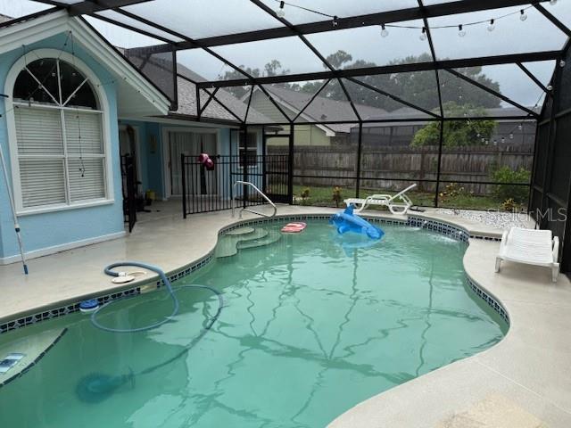 2514 Dovetail Dr, Ocoee, FL 34761 - view of swimming pool featuring a patio area and glass enclosure