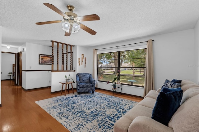 1830 W Clinton Dr, Saint Cloud, FL 34769 - living area featuring a textured ceiling, a ceiling fan, wood finished floors, and baseboards