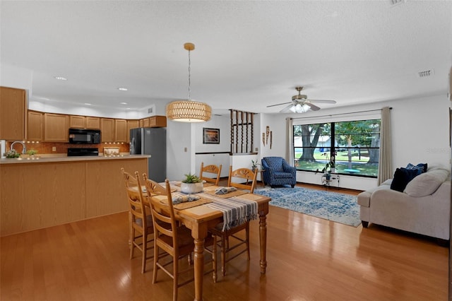 1830 W Clinton Dr, Saint Cloud, FL 34769 - dining area featuring light wood-style floors, a ceiling fan, and recessed lighting