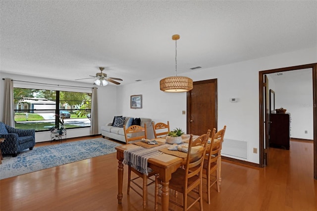 1830 W Clinton Dr, Saint Cloud, FL 34769 - dining space with wood finished floors, ceiling fan, and a textured ceiling