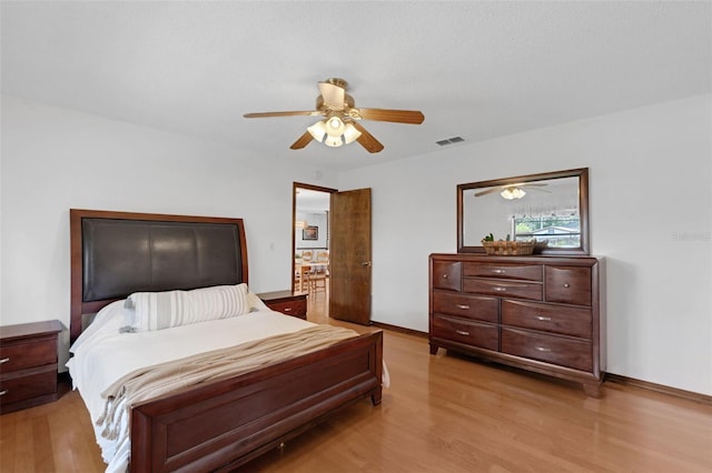 1830 W Clinton Dr, Saint Cloud, FL 34769 - bedroom with light wood-type flooring, baseboards, and a ceiling fan