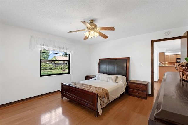 1830 W Clinton Dr, Saint Cloud, FL 34769 - bedroom with wood finished floors, a textured ceiling, baseboards, and ceiling fan