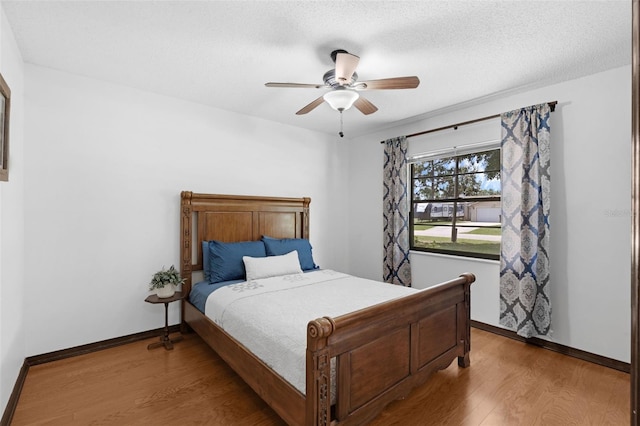 1830 W Clinton Dr, Saint Cloud, FL 34769 - bedroom featuring wood finished floors, baseboards, and a ceiling fan
