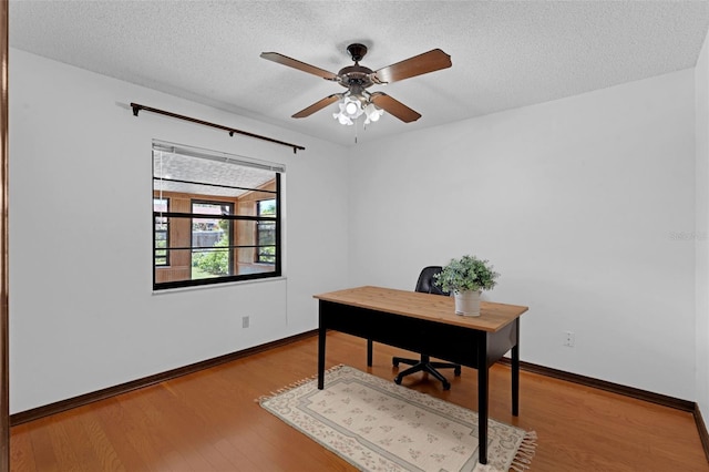 1830 W Clinton Dr, Saint Cloud, FL 34769 - home office with wood finished floors, a textured ceiling, baseboards, and a ceiling fan