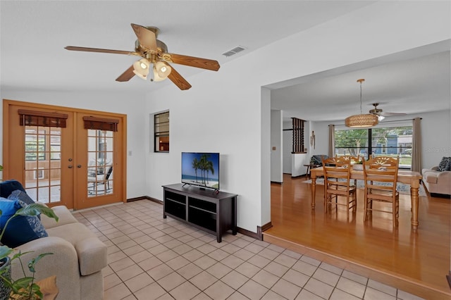 1830 W Clinton Dr, Saint Cloud, FL 34769 - living room featuring ceiling fan, french doors, light tile patterned floors, and baseboards