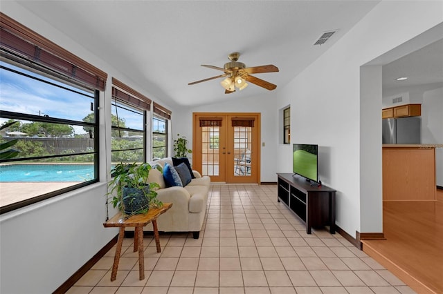 1830 W Clinton Dr, Saint Cloud, FL 34769 - living room featuring a ceiling fan, baseboards, light tile patterned floors, vaulted ceiling, and french doors