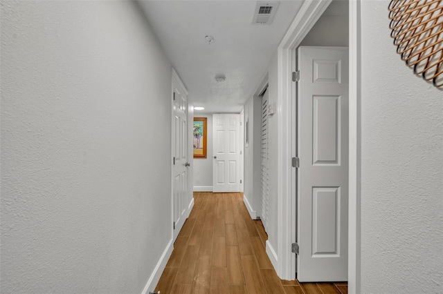 5207 S Atlantic Ave Unit 225, New Smyrna Beach, FL 32169 - corridor featuring baseboards and wood finished floors