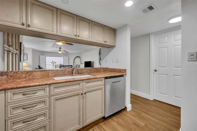 5207 S Atlantic Ave Unit 225, New Smyrna Beach, FL 32169 - kitchen with dishwasher, a sink, a ceiling fan, cream cabinetry, and light wood-style floors