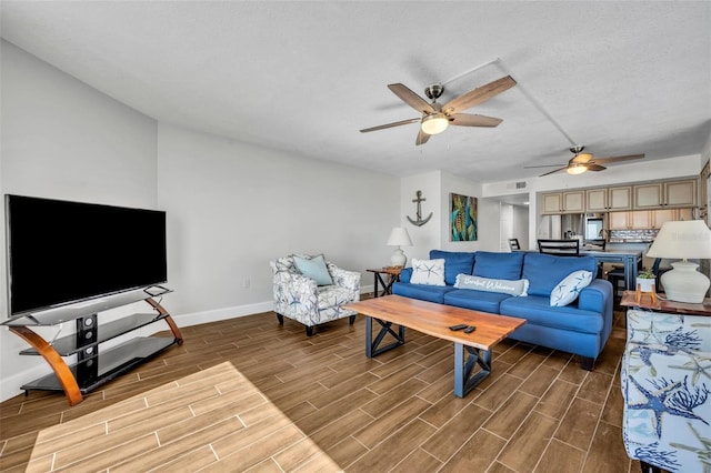 5207 S Atlantic Ave Unit 225, New Smyrna Beach, FL 32169 - living area featuring baseboards, a ceiling fan, wood finished floors, and a textured ceiling