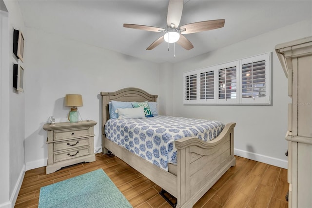 5207 S Atlantic Ave Unit 225, New Smyrna Beach, FL 32169 - bedroom featuring baseboards, wood finished floors, and ceiling fan