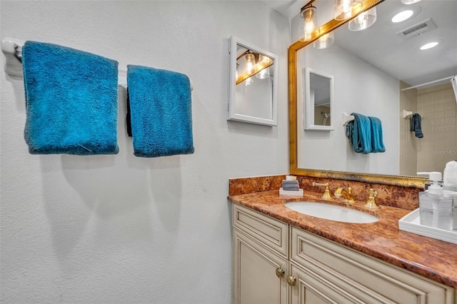 5207 S Atlantic Ave Unit 225, New Smyrna Beach, FL 32169 - bathroom featuring vanity and a tile shower