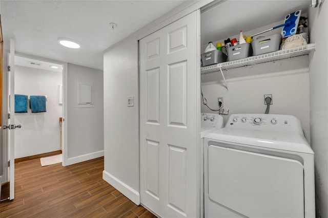5207 S Atlantic Ave Unit 225, New Smyrna Beach, FL 32169 - laundry room with baseboards, washer and dryer, and dark wood finished floors
