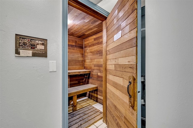 5207 S Atlantic Ave Unit 225, New Smyrna Beach, FL 32169 - relaxing sauna / steam room featuring wooden ceiling, wooden walls, and tile patterned flooring