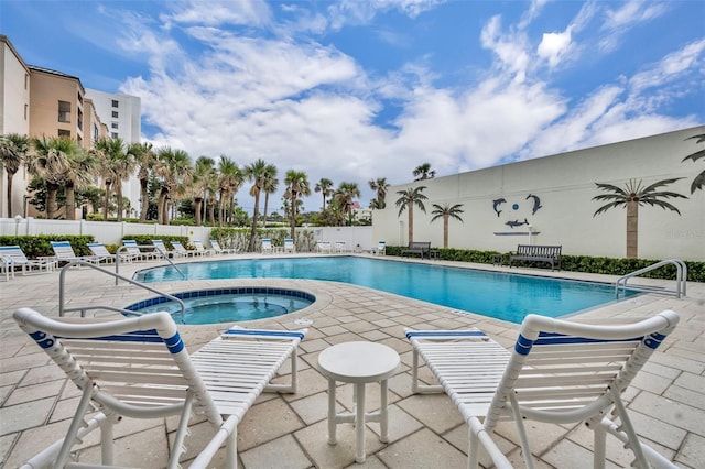 5207 S Atlantic Ave Unit 225, New Smyrna Beach, FL 32169 - community pool with a community hot tub, a patio area, and fence