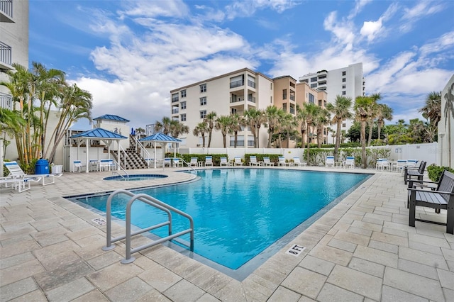 5207 S Atlantic Ave Unit 225, New Smyrna Beach, FL 32169 - community pool featuring fence, a community hot tub, a patio area, and a gazebo