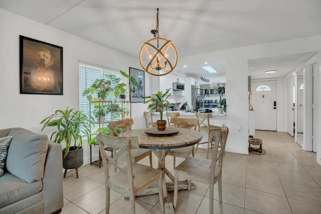 5635 Blue Shadows Ct Unit 3, Orlando, FL 32811 - dining room featuring light tile patterned floors and a chandelier