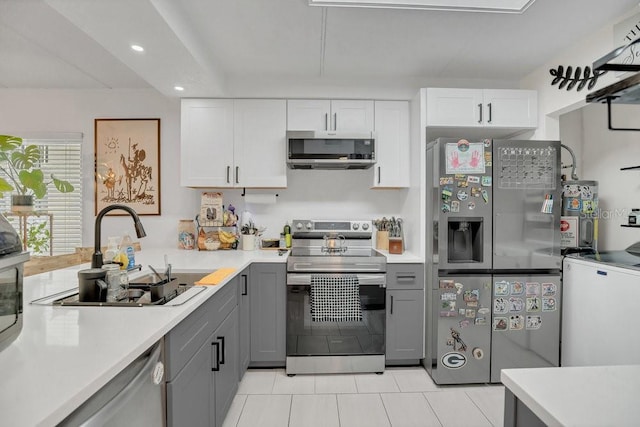 5635 Blue Shadows Ct Unit 3, Orlando, FL 32811 - kitchen featuring appliances with stainless steel finishes, gray cabinetry, light tile patterned flooring, light countertops, and recessed lighting