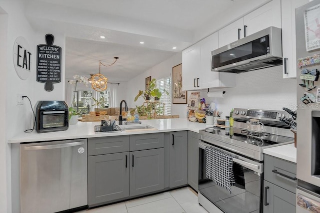 5635 Blue Shadows Ct Unit 3, Orlando, FL 32811 - kitchen with stainless steel appliances, gray cabinetry, light countertops, and recessed lighting
