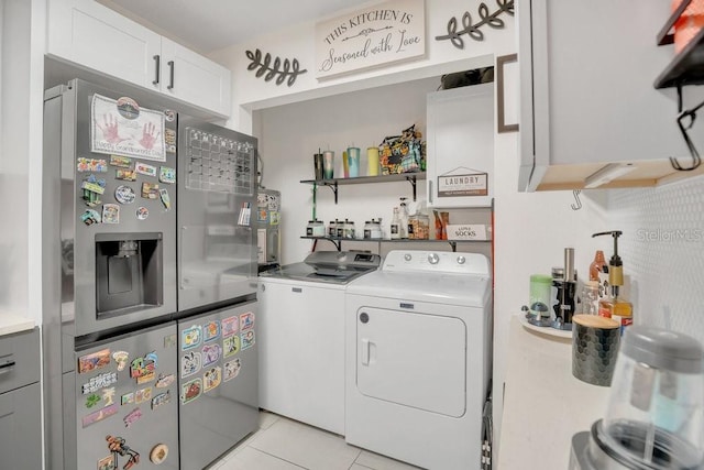 5635 Blue Shadows Ct Unit 3, Orlando, FL 32811 - laundry area with independent washer and dryer and light tile patterned floors