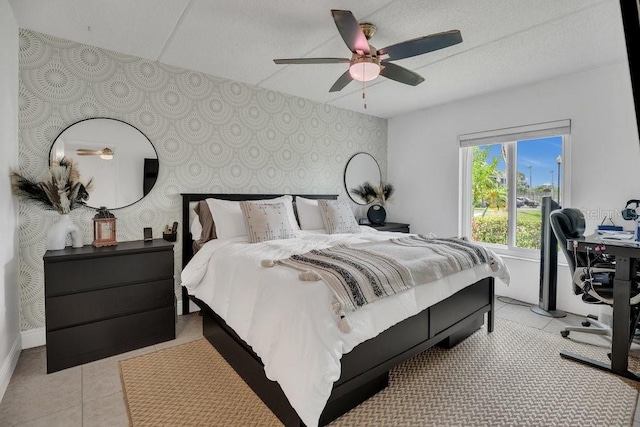 5635 Blue Shadows Ct Unit 3, Orlando, FL 32811 - bedroom featuring wallpapered walls, an accent wall, light tile patterned flooring, ceiling fan, and a desk