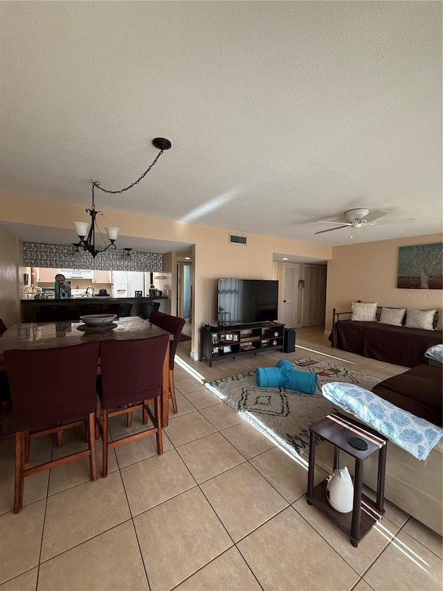 821 Pinewood Ct Unit 821, Haines City, FL 33844 - living area with a chandelier, a textured ceiling, light tile patterned floors, and ceiling fan